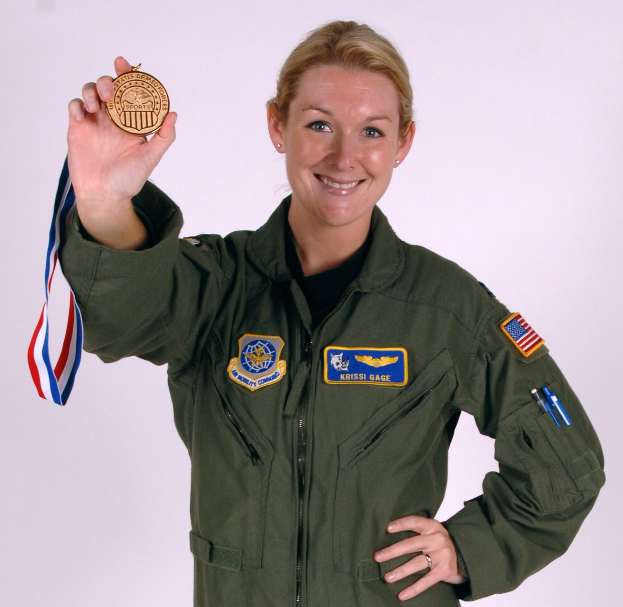Capt. Krissi Gage, a pilot with the 905th Air Refueling Squadron and a member of the Air Force volleyball team, shows off her gold medal that the volleyball team won in the 2010 All-Forces Volleyball Championship at Marine Corps Air Station Cherry Point, N.C. May 3 through 11. It was Captain Gage’s first time competing in the championship. (U.S. Air Force photo by Airman 1st Class Amber Price)