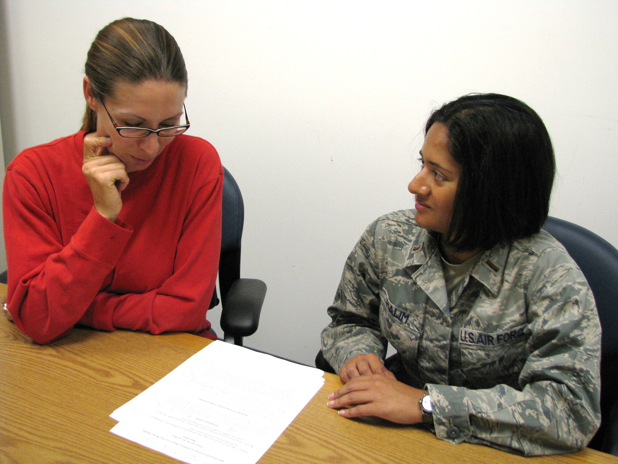 Jeanette Van Norden, 95th Aerospace Medicine Squadron, environmental health technician (left) and 2nd Lt. Nadia Halim, 95th AMDS, environmental element chief for Bioenvironmental, discuss this year's tap water quality report for Edwards.
