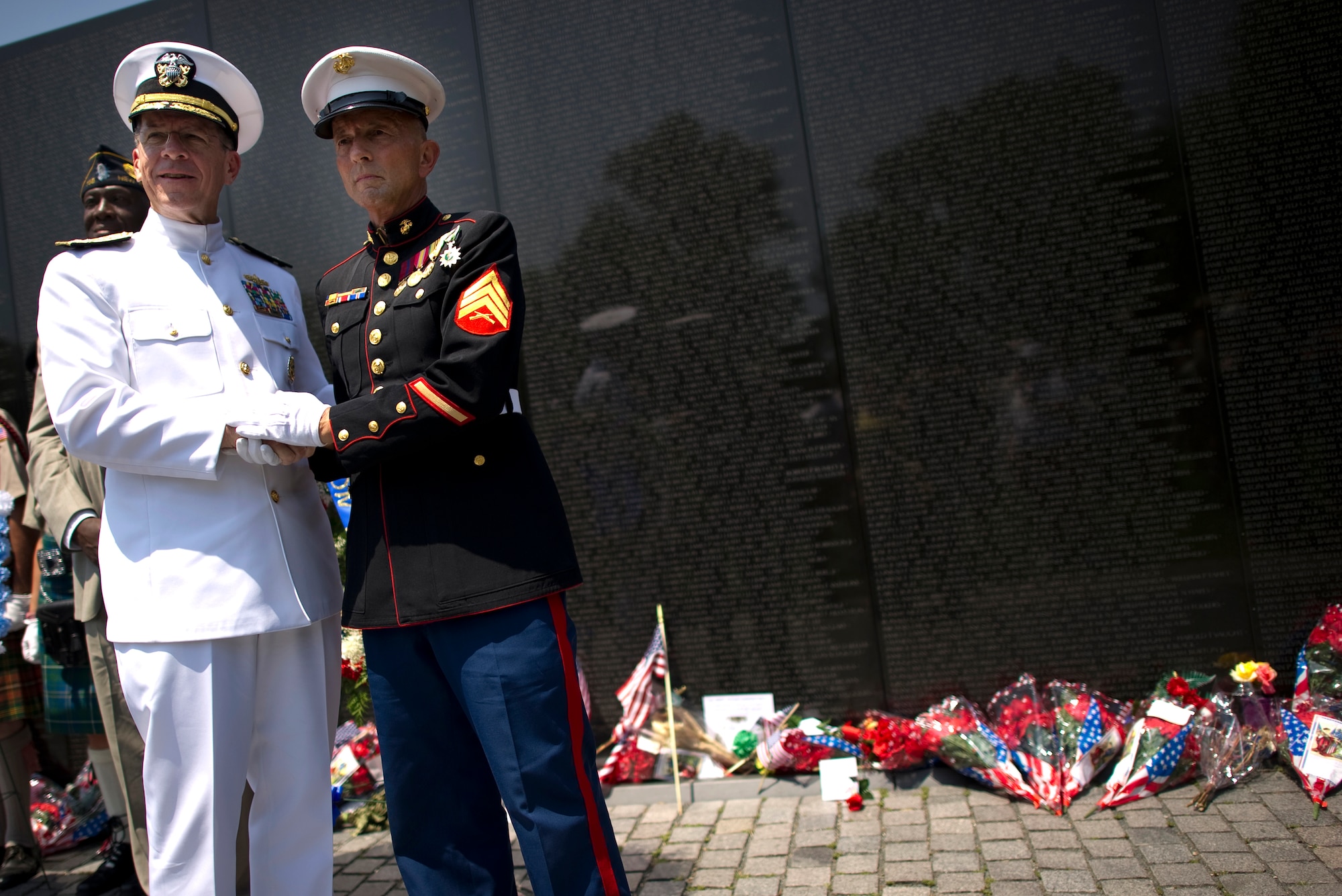 Adm. Mike Mullen, chairman of the Joint Chiefs of Staff, visits with U.S. Marine and Vietnam Veteran Sgt. Paul Masi May 31, 2010, at the annual Memorial Day Observance Ceremony at the Vietnam Veterans Memorial in Washington, D.C.  (Defense Department photo/Petty Officer 1st Class Chad J. McNeeley)