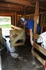 MINOT, N.D. -- Jake Wieland, sprays out the stables at the Roosevelt Park Zoo here May 17.  Jake is one of the many friends one may see on a visit to the zoo and is responsible for helping with upkeep of the park. Every year the zoo hosts a military appreciation day. This year’s event is scheduled for June 16. (U.S. Air Force photo by Tech. Sgt. Lee A. Osberry, Jr.)