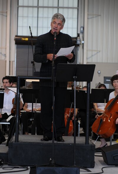 SEYMOUR JOHNSON AIR FORCE BASE, N.C. -- Grant Llewellyn addresses the audience before the North Carolina Symphony performs June 1, 2010. Mr. Llewellyn is the conductor of the North Carolina Symphony which performed as part of the group's Red White & Blue Tour. The tour pays tribute to the men and women who have kept America safe for generations. Mr. Llewellyn is a native of Tenby, Wales. (U.S. Air Force photo/Senior Airman Gino Reyes)