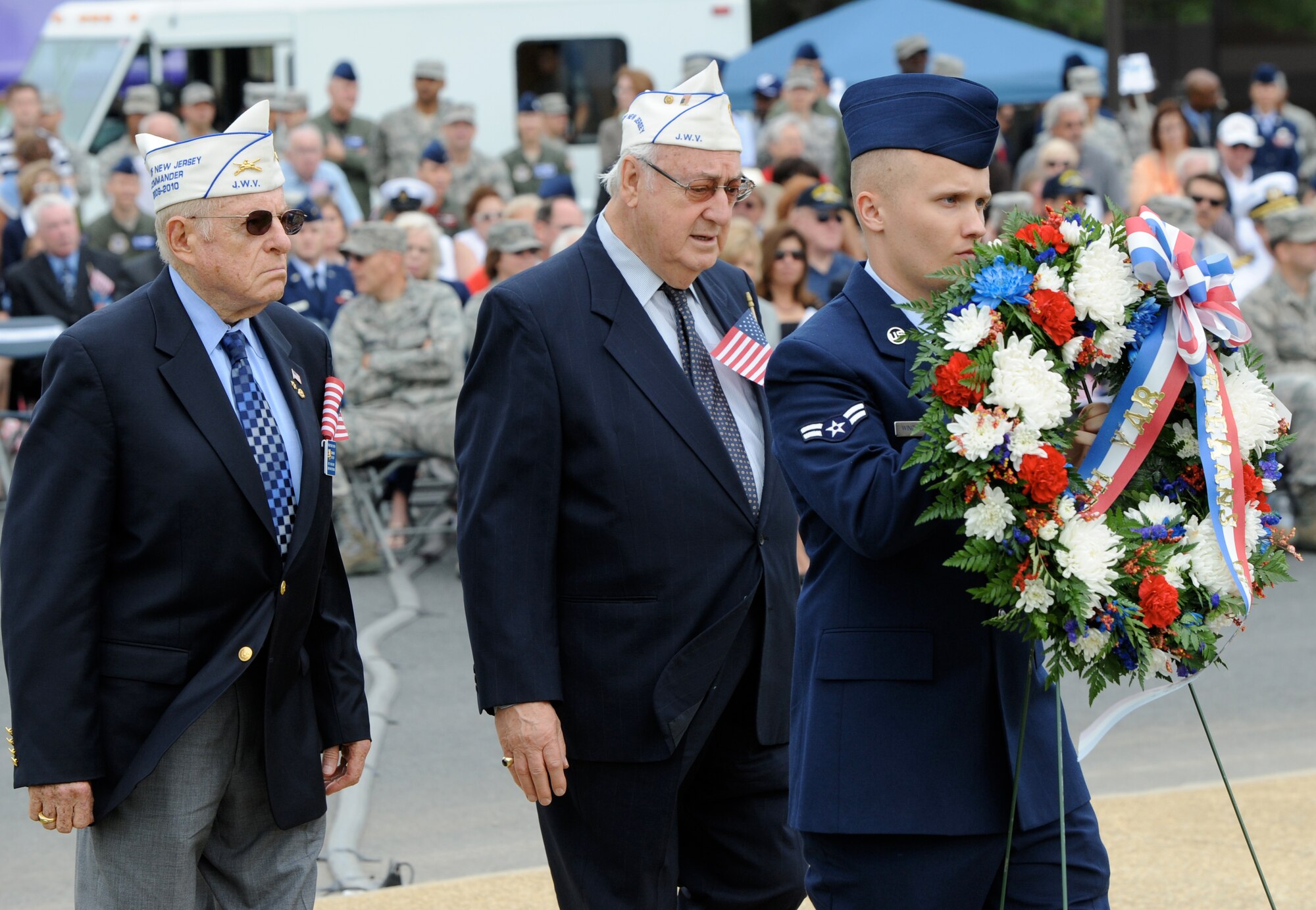 Airman 1st Class John Windle, 305th Maintenance Squadron, carries a wreath to Pudgy Circle during the Parade of Wreaths ceremony May 27 here. Joint Base McGuire-Dix-Lakehurst, the Thomas B. McGuire Jr. Foundation and the New Jersey State Police annually commemorate Memorial Day with the Parade of Wreaths ceremony. Local, military and retired auxiliaries join the local community and police officers to  honor the nation’s fallen heroes by donating wreaths. (U.S. Air Force photo/Wayne Russell)