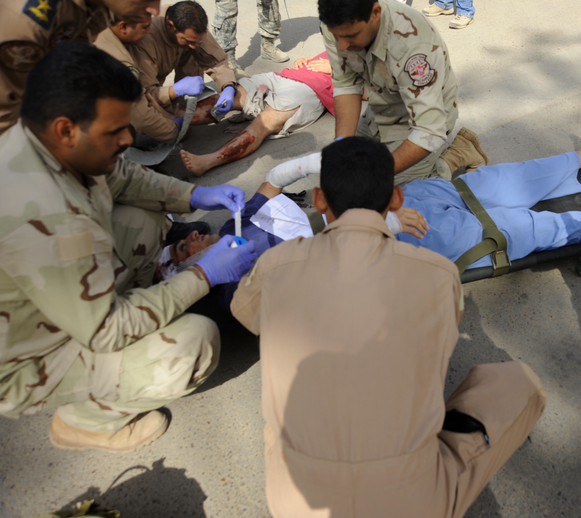 Member of the Iraqi military provide medical treatement to a simulated wounded person during an exercise May 20, 2010, at Joint Base Balad, Iraq. Iraqi forces from Al-Muthana, Camp Taji and New Al-Muthana participated in training that demonstrated their abilities to assess and treat different conditions that may happen in a combat environment. (U.S. Air Force photo)