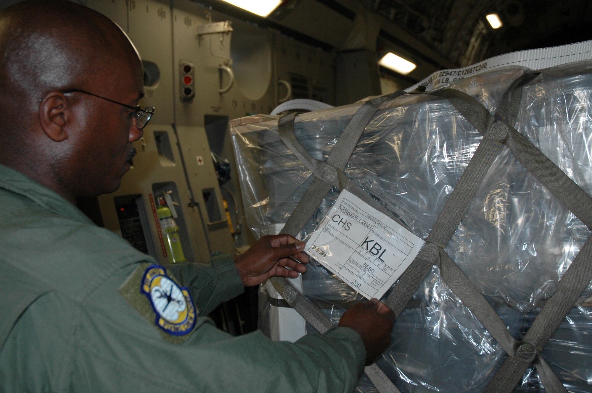 Tech Sergeant Robert Porter checks the paperwork on a shipment of soybean seeds on its way to Kabul Air Base Afghanistan May 30. The seeds were taken from Charleston Air Force Base, S.C. as a part of the Denton Humanitarian Assistance Program. (U.S. Air Force Photo/2nd Lt Joe Simms)