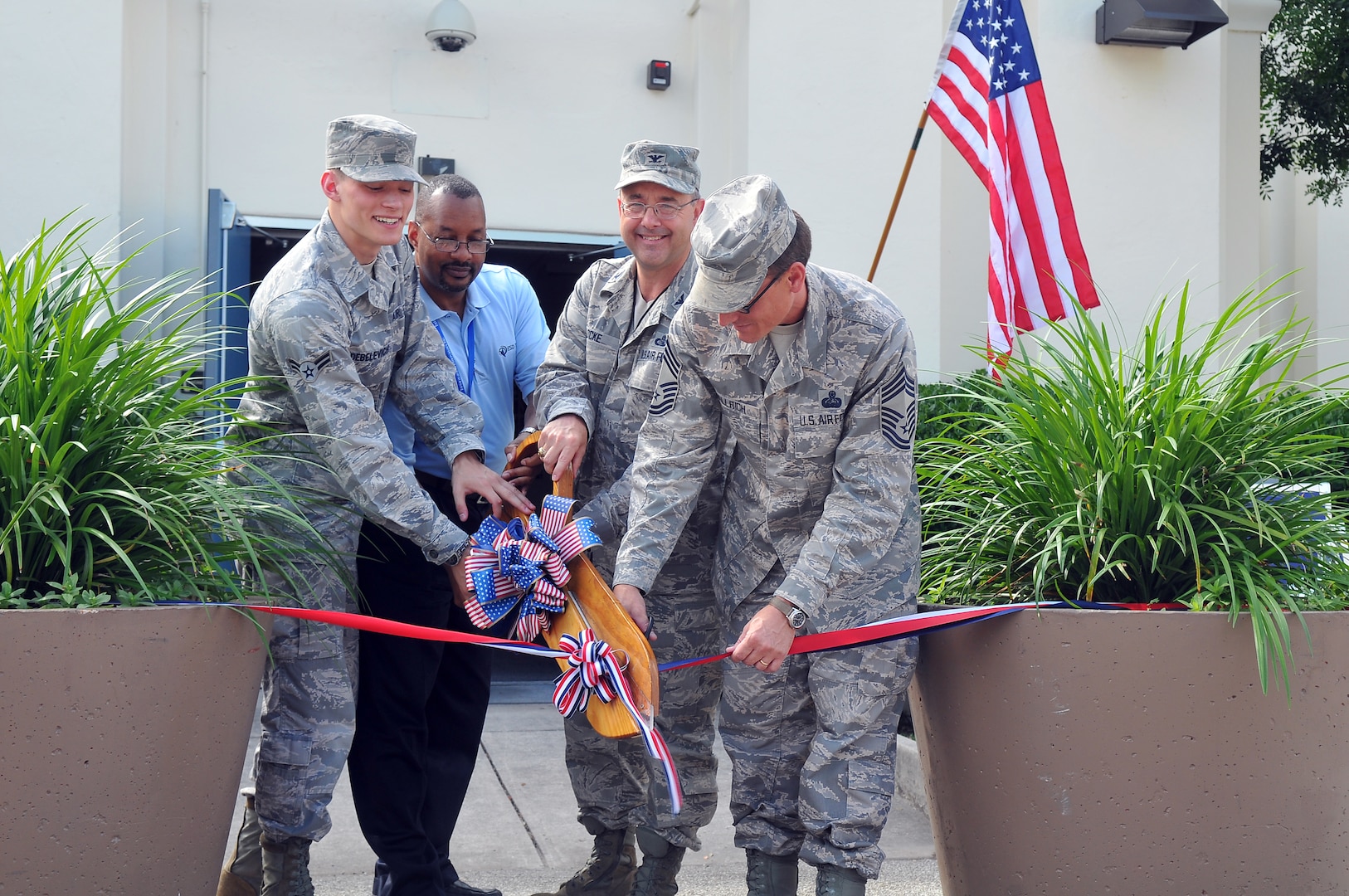 Airman 1st Class Jason Debelevich, 690th Network Support Squadron Enterprise Service Desk technician, Eric Dudley, ESD technician, Col. Donald C. Lock, 690th Network Support Group commander, and Chief Master Sgt. James Wallrich, 690th NSS Superintendent, cut the ribbon at the grand opening of the 690th Network Support Squadron’s newest location of the Air Force Enterprise Service Desk May 27. Helpdesks are transitioning from independently operated and managed entities at the base or major command level, to a single virtualized AF information technology ESD geographically dispersed across four world-wide locations, operating within one logical Air Force network domain.  The remaining helps desks are located at Ramstein Air Base, Germany; Maxwell AFB-Gunter Annex, Ala. and Hickam AFB, Hawaii. (US Air Force photo by Ted Koniares)