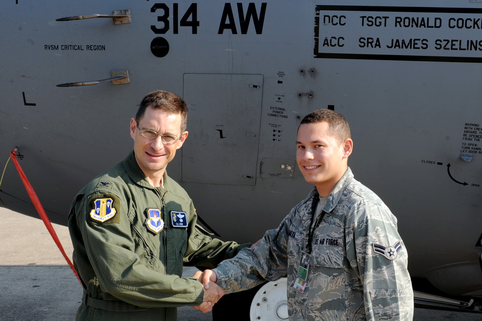 Col. Charles K. Hyde, 314th Airlift Wing commander, presents a coin June 2 to Airman 1st Class Damian Maya, 314th Aircraft Maintenance Squadron aerospace maintenance apprentice, for his selection as the Combat Airlifter of the Week. Airman Maya completed all upgrade tasks and received an 85 percent on his end-of-course career development course. (U.S. Air Force photo by Senior Airman Ethan Morgan)