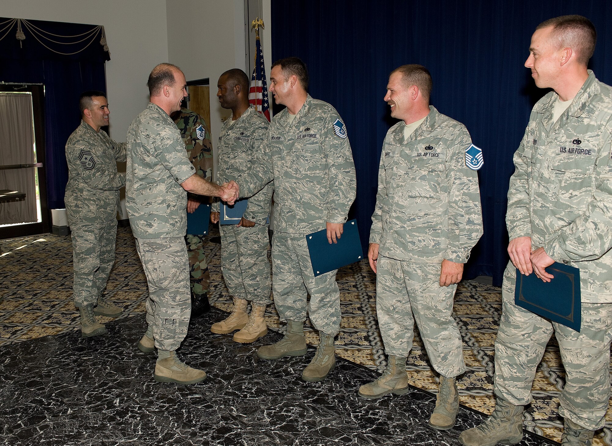Col. Manson Morris, 436th Airlift Wing Commander, and Chief Master Sgt. John Evalle, 436th AW Command Chief, congratulate Team Dover master sergeant selectees at The Landings Club, Dover Air Force Base, Del., May 27, 2010. Team Dover had 41 members selected to be promoted to the rank of master sergeant. (U.S. Air Force photo by Jason Minto/Released) 