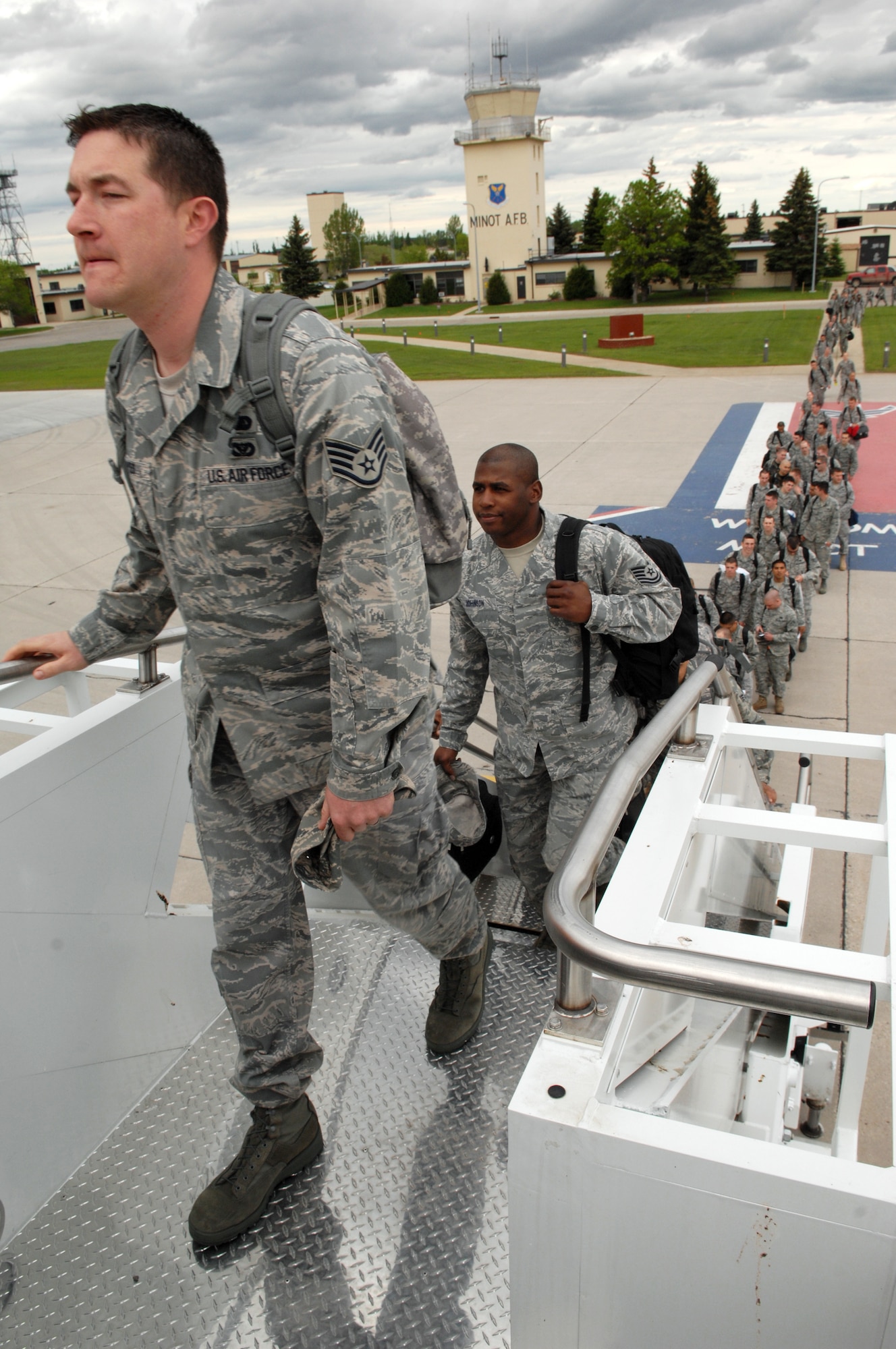 MINOT AIR FORCE BASE, N.D. -- Airmen from the 5th Bomb Wing board a Boeing 767 on their way to Andersen AFB, Guam, here May 31. The 5th BW is part of deployment rotation that provides U.S. Pacific Command with a continuous bomber presence in the Asia-Pacific region. (U.S. Air Force photo by Senior Airman Michael J. Veloz)