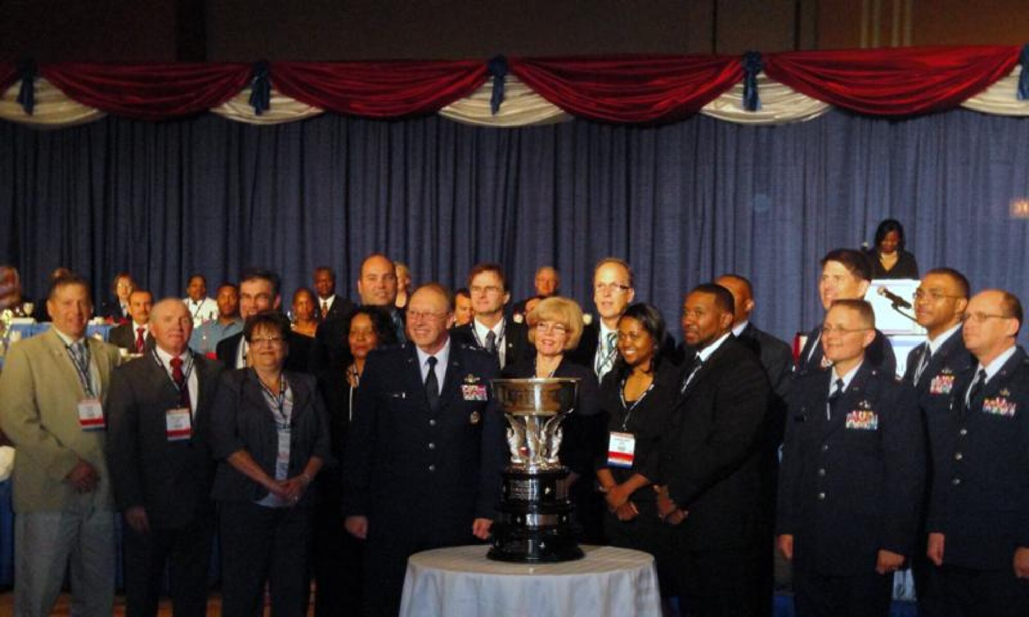 Team Keesler leaders and food service team members accept the 2010 Hennessy Award recognizing the top multiple facility food service team in the Air Force May 22 in Chicago.  The Keesler contingent included Brig. Gen. Ian Dickinson, 81st Training Wing commander; Chief Master Sgt. Lonnie Slater, wing command chief; Col. Jeffrey Jackson, 81st Mission Support Group commander; Lt. Col. Richard Cole, 81st Force Support Squadron commander; John Thurmon, Carmen Steed, Glenn Jones, Roy Jackson, Andre Simmons and Eleanor Harvey, 81st FSS members; and Floyd Austin, Mark Austin, Stephen Grandonico, Robin Grandonico, Bill Cox, Michelle Cox, Sharon Touchet, Linda Robertson and Brenda Turner from A&A Food Service Inc., the base’s food service contractor.  It’s the sixth time that Keesler has won the Hennessy Award, which recognizes excellence based on the entire scope of an installation’s food service program.  (Courtesy photo)