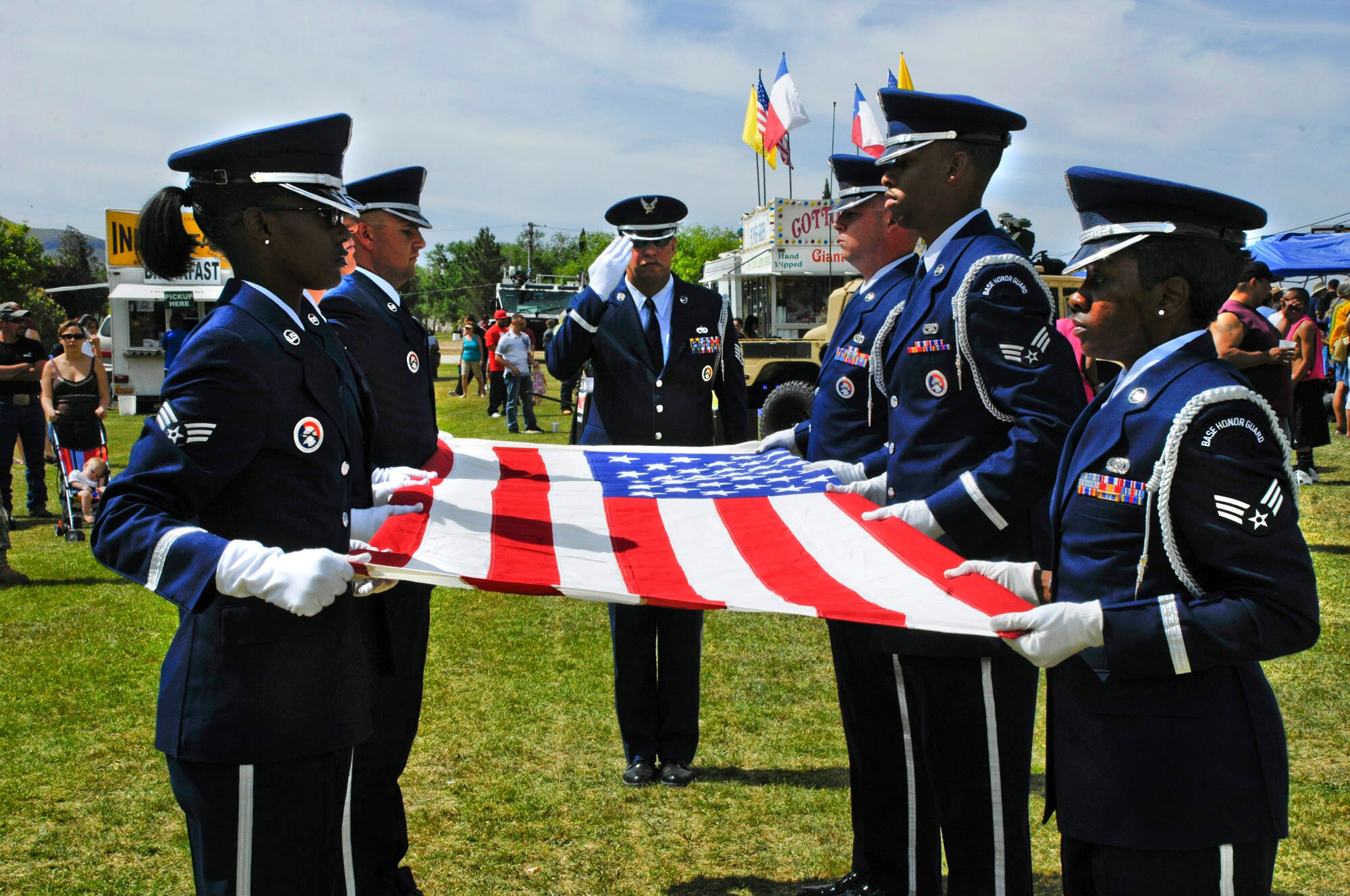 ALAMOGORDO, N.M. -- Holloman Air Force Base?s Honor Guard demonstrates their flag-folding ceremony during Alamogordo's salute to the military held on Armed Forces Day May 15, 2010. The Steel Talons perform similar flag-folding ceremonies for fallen veterans throughout the region. About 10,000 people came out to Washington Park on the sunny day to watch military demonstrations like the Honor Guard's and view several static exhibits from Holloman Air Force Base. (U.S. Air Force photo by Tom Fuller / Released)