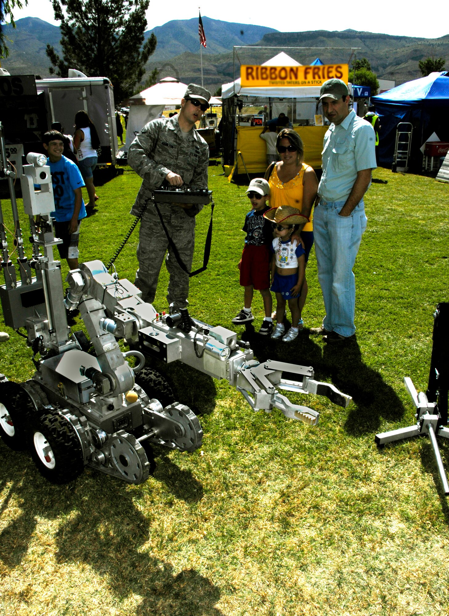 ALAMOGORDO, N.M. ? Airman 1st Class Brook Hamilton, 49th Civil Engineering Squadron Explosive Ordinance Disposal Flight, uses a remote control box to demonstrate to spectators the nimbleness of a robot used to disarm explosives during the local Armed Forces Day Celebration May 15, 2010. This demonstration was one of many provided by Holloman Air Force Base Airmen at the Armed Forces Day Celebration. (U.S. Air Force photo by Tom Fuller / Released)
