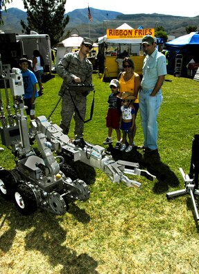 ALAMOGORDO, N.M. ? Airman 1st Class Brook Hamilton, 49th Civil Engineering Squadron Explosive Ordinance Disposal Flight, uses a remote control box to demonstrate to spectators the nimbleness of a robot used to disarm explosives during the local Armed Forces Day Celebration May 15, 2010. This demonstration was one of many provided by Holloman Air Force Base Airmen at the Armed Forces Day Celebration. (U.S. Air Force photo by Tom Fuller / Released)