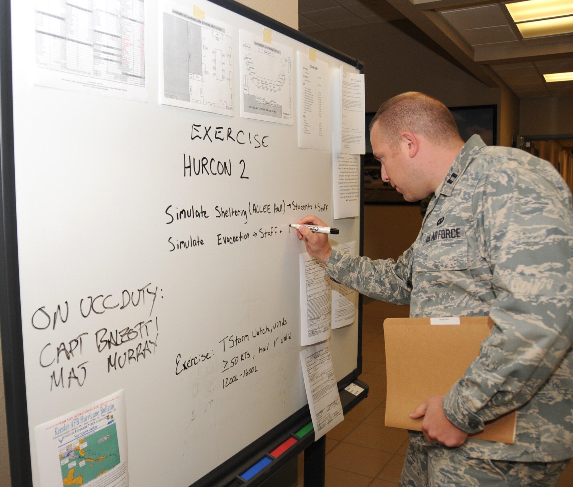 Capt. Michael Balzotti, 334th Training Squadron, updates the hurricane condition status board in Cody Hall May 26 during Keesler’s week-long exercise to test the base’s hurricane preparations and response.  Hurricane season began Tuesday.  (U.S. Air Force photo by Kemberly Groue)
