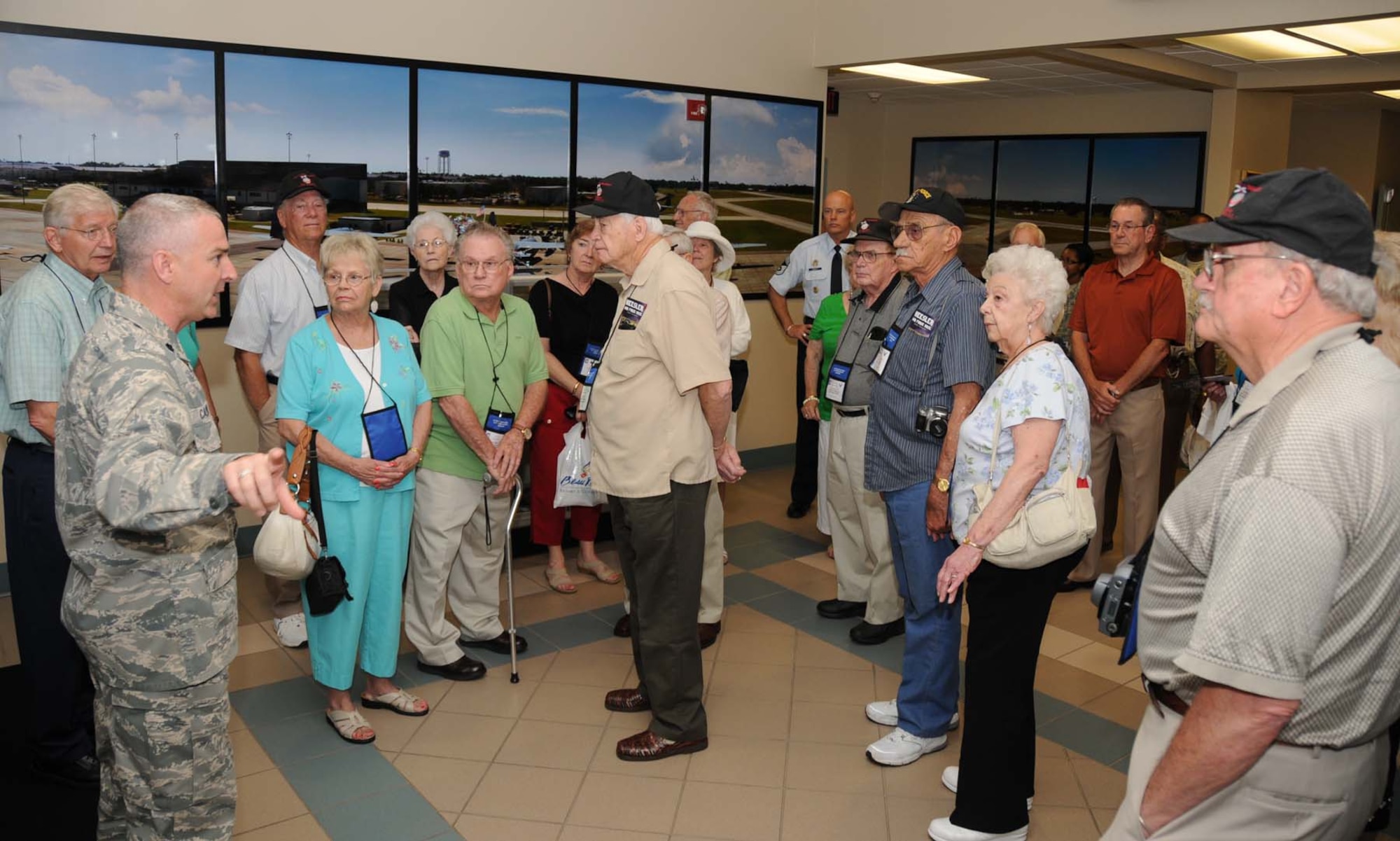 Lt. Col. Michael Callender, left, 334th Training Squadron commander, welcomes members of the 1979th Air and Airwaves Communications Service Squadron members to Keesler’s air traffic control schoolhouse May 26.  It was the third reunion of the AACS Squadron since its air traffic controllers and radar operators trained at Keesler in the early 1950s.  (U.S. Air Force photo by Kemberly Groue)