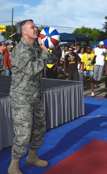 ALAMOGORDO, N.M. -- Col. David Sullivan, 49th Fighter Wing vice commander, sets up to shoot the ceremonial first free throw to open the Gus Macker 3-on-3 Basketball Tournament held in conjunction with Alamogordo's Armed Forces Day Celebration, May 15, 2010, at Washington Park. About 2,000 players and spectators watched the opening ceremony that included a fly-over by F-22 Raptors from Holloman Air Force Base, the invocation given by Holloman Chaplain (Maj.) Sheila Wilson and the national anthem sung by Skip Hoffman, civilian employee of the 49th Logistics Readiness Squadron. (U.S. Air Force photo by Tom Fuller / Released)