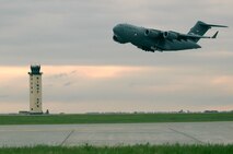 MINOT AIR FORCE BASE, N.D. -- A C-17 Globemaster III full of supplies and equipment for the members of the 5th Bomb Wing deploying to Andersen AFB, Guam, takes off from here May 27. The deployment is in support of U.S. Pacific Command’s continuous bomber presence in the Asia-Pacific region. (U.S. Air Force photo by Airman 1st Class Aaron-Forrest Wainwright)