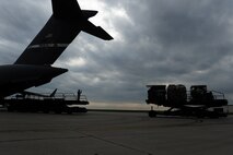 MINOT AIR FORCE BASE, N.D. -- Airmen from the 5th Logistics Readiness Squadron load pallets of equipment onto a C-17 Globemaster III out of Travis AFB, Calif., during deployment preparation here May 27. Airmen from the 5th Bomb Wing are preparing to deploy to Andersen AFB, Guam, in support of U.S. Pacific Command’s continuous bomber presence in the Asia-Pacific region. (U.S. Air Force photo by Tech. Sgt. Lee A. Osberry, Jr.)