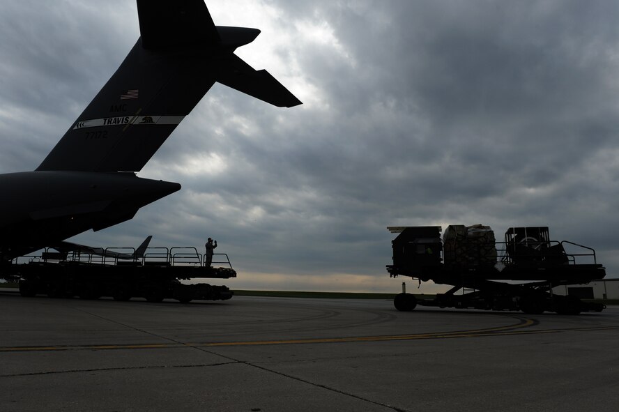 MINOT AIR FORCE BASE, N.D. -- Airmen from the 5th Logistics Readiness Squadron load pallets of equipment onto a C-17 Globemaster III out of Travis AFB, Calif., during deployment preparation here May 27. Airmen from the 5th Bomb Wing are preparing to deploy to Andersen AFB, Guam, in support of U.S. Pacific Command’s continuous bomber presence in the Asia-Pacific region. (U.S. Air Force photo by Tech. Sgt. Lee A. Osberry, Jr.)