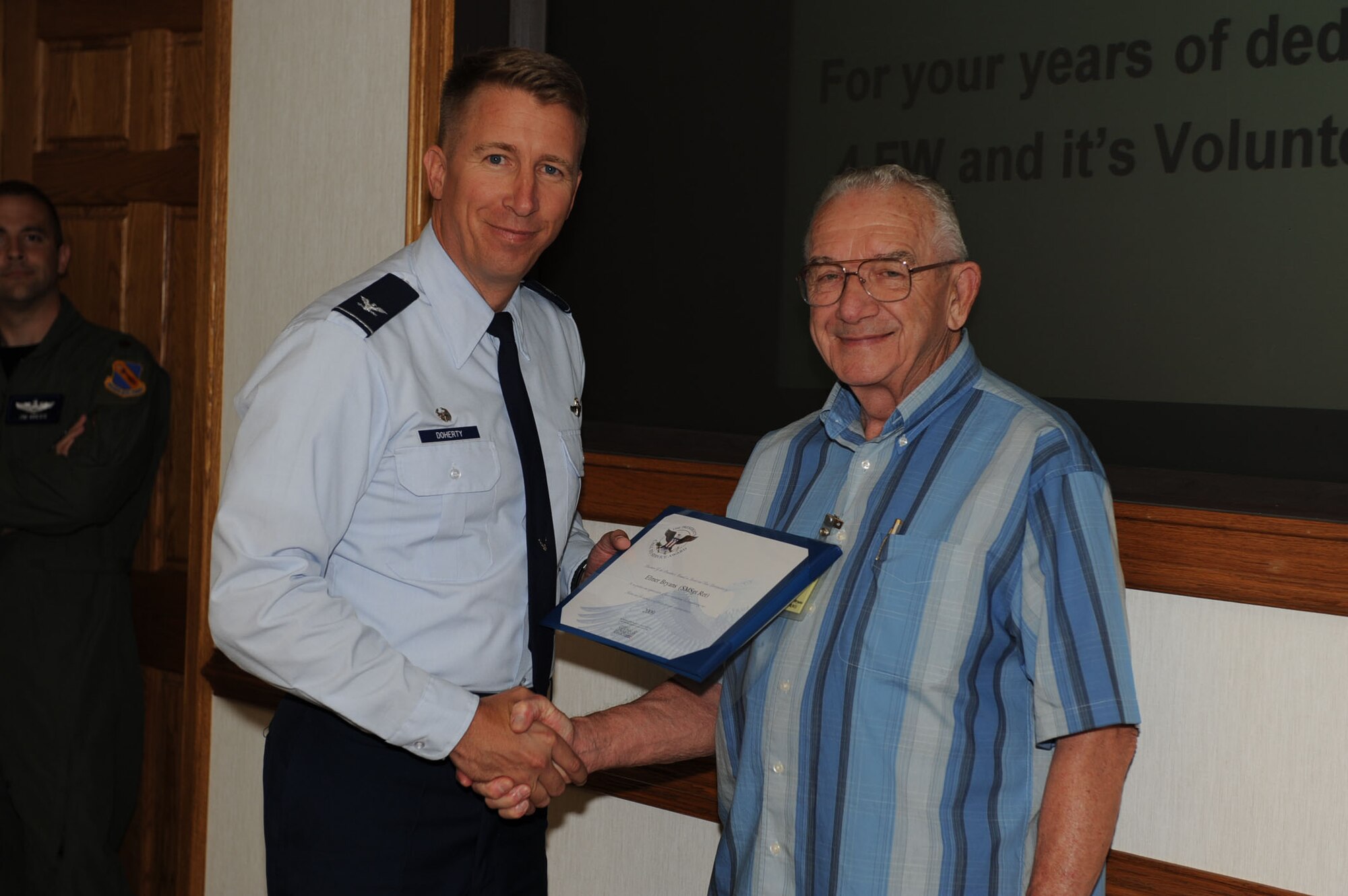 SEYMOUR JOHNSON AIR FORCE BASE, N.C. -- Elmer Bryans receives a certificate of appreciation from Col. Patrick Doherty May 27, 2010. Mr. Bryans, a retired senior master sergeant, has been volunteering at the Retirees Activities Office since 2004. Mr. Bryans is officially retiring after nearly 60 years of dedicated service to the Air Force. (U.S. Air Force photo/Senior Airman Gino Reyes)