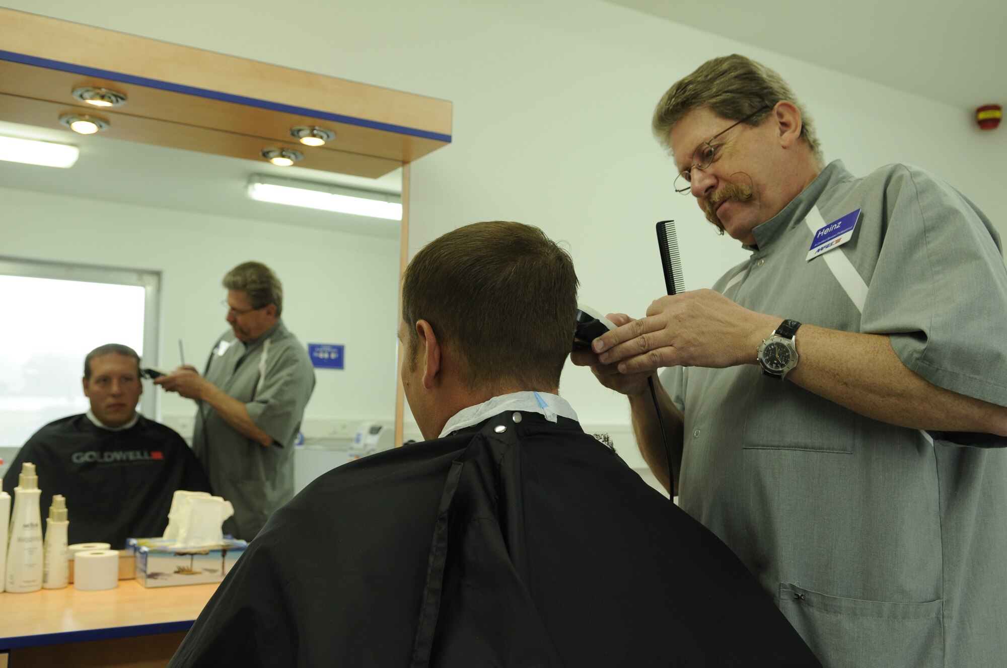 SPANGDAHLEM AIR BASE, Germany – Heinz Willems, Army & Air Force Exchange Service barber, gives a haircut to Staff Sgt. Richard Armpriester, 52nd Aircraft Maintenance Squadron, in the Jet Blast barbershop June 1. The Jet Blast is located in Bldg. 160 on the flightline and offers delivery of hot meals, a barbershop, computer access and more. (U.S. Air Force photo/Senior Airman Benjamin Wilson)