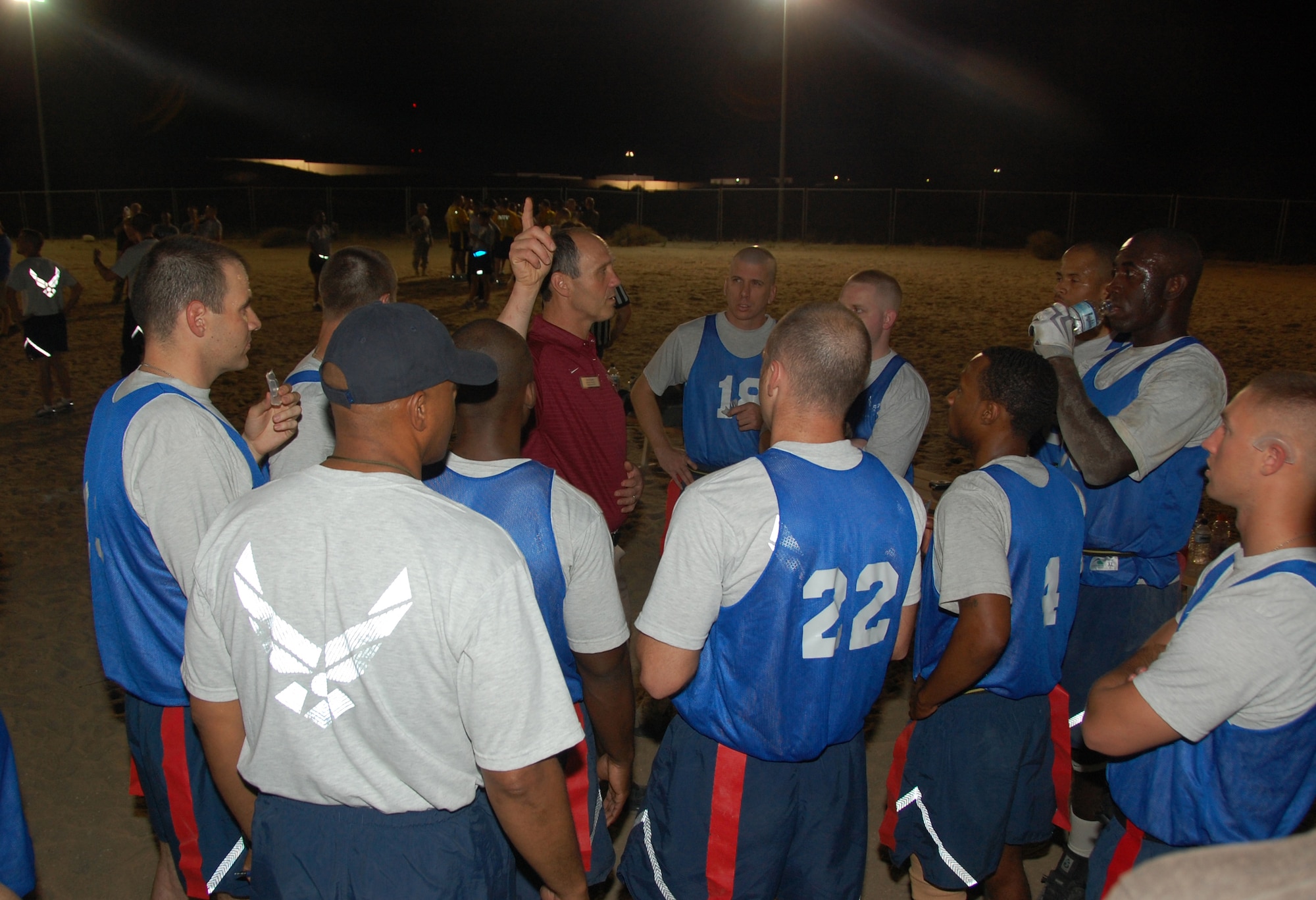 Tim Murphy, head football coach of Harvard University, gives "The Rock" Air Force football team some halftime advice during a friendly flag football game here May 29, 2010 between the air base team and the Army's Life Support Area adjacent to the base. The LSA beat "The Rock" 12-8. (U.S. Air Force photo by Tech. Sgt. Lindsey Maurice/Released)