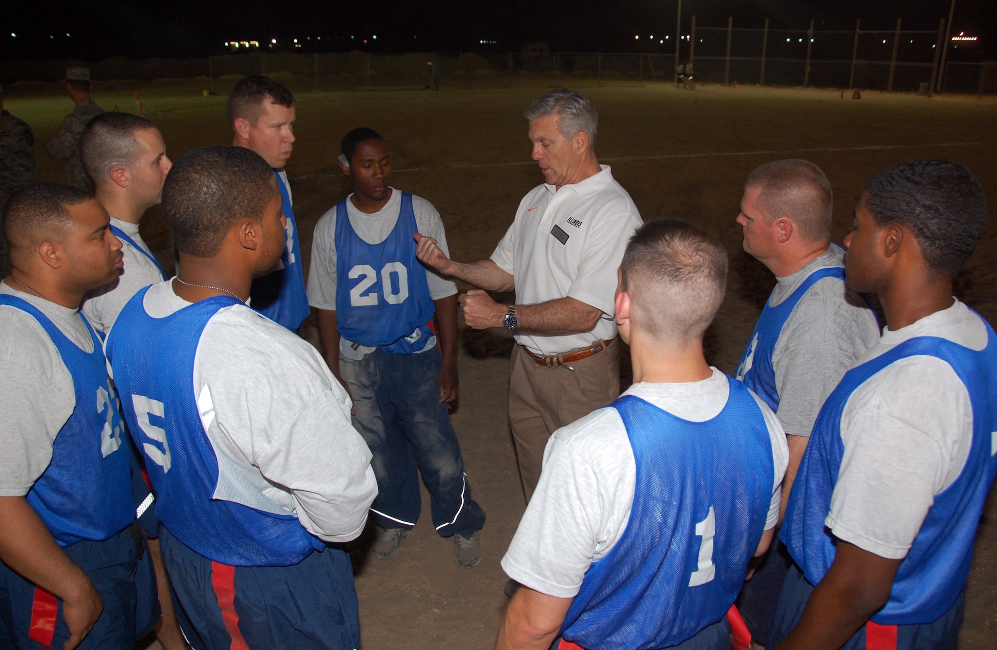 Ron Zook, University of Illinois head football coach, gives "The Rock" Air Force football team some halftime advice during a friendly flag football game here May 29, 2010 between the air base team and the Army's Life Support Area adjacent to the base. The LSA beat "The Rock" 12-8. (U.S. Air Force photo by Tech. Sgt. Lindsey Maurice/Released)