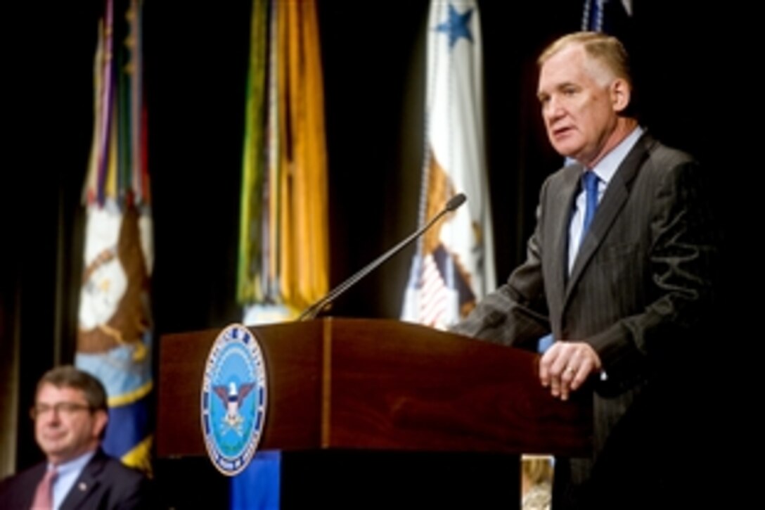 Deputy Defense Secretary William J. Lynn III addresses the audience as Ashton B. Carter, undersecretary of defense for acquisition, technology and logistics, looks on during the 2010 Environmental Awards ceremony at the Pentagon, June 2, 2010.


