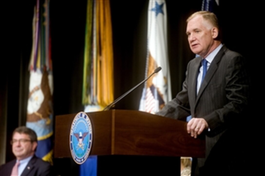 Deputy Secretary of Defense William J. Lynn III addresses the audience as Under Secretary of Defense for Acquisition, Technology and Logistics Ashton B. Carter looks on during the 2010 Environmental Awards ceremony in the Pentagon on June 2, 2010.  