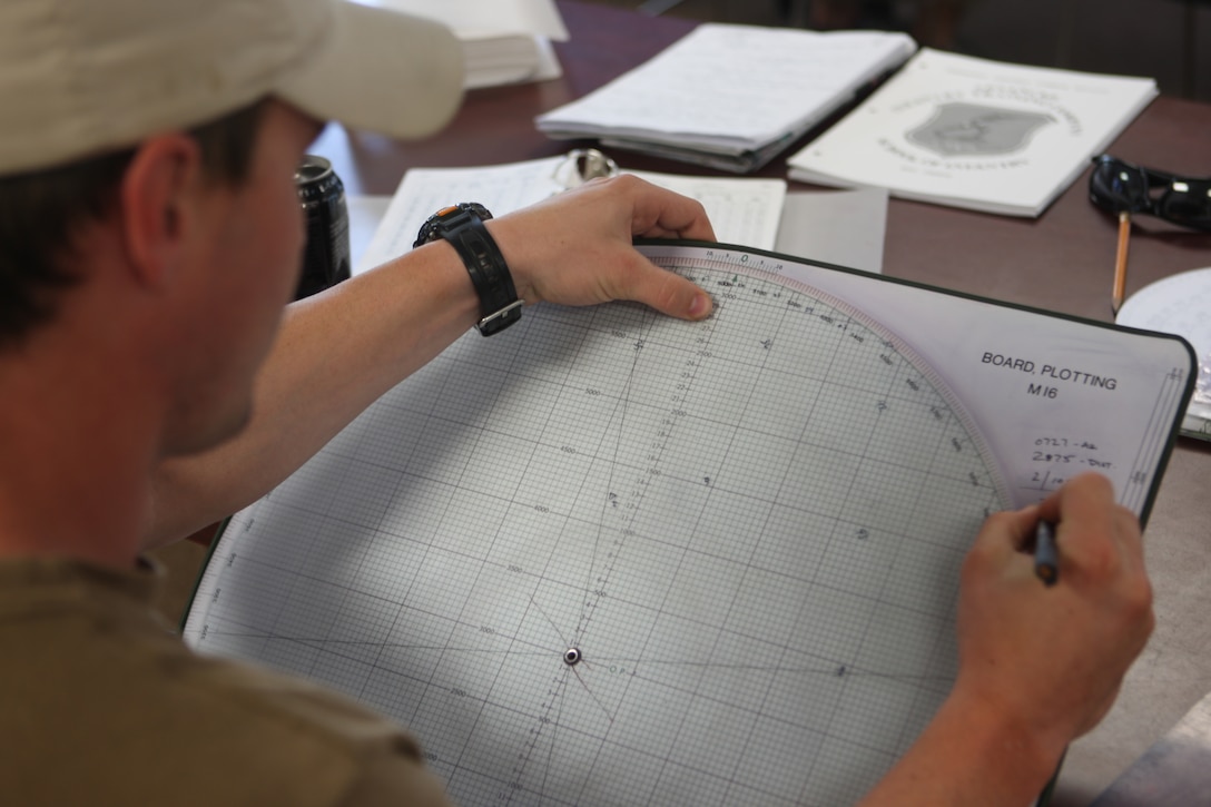 A Navy SEAL from the Joint Expeditionary Base Little Creek – Fort Story, Va., calculates where to plot certain points on a mortar plotting board during a class of the Infantry Mortars Leader Course, part of the Advanced Infantry Training Battalion, Camp Geiger, recently. In order to further their training and combat-readiness, the SEAL unit cross-trained with Marines to familiarize themselves with the mortar system in the event its advantage is needed in combat.