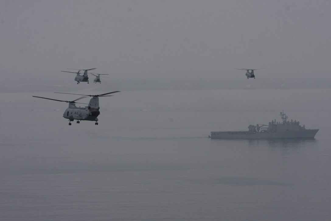 Four CH-46 Sea Knight helicopters circle the USS Bonhomme Richard June 3 before exercise Dawn Blitz. The exercise demonstrated the nation’s ability to go ashore and seize and hold enemy ground.