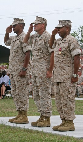 (From left to right) Col. Craig C. Crenshaw, the commanding officer of Combat Logistics Regiment 25, 2nd Marine Logistics Group; Sgt. Maj. Charles T. Blumenberg, the incoming sergeant major of CLR-27; and Sgt. Maj. Adam C. Terry, the outgoing sergeant major of the regiment, salute the colors during the playing of the Marines’ Hymn and Anchors Aweigh at a post and relief ceremony aboard Camp Lejeune, N.C., June 3, 2010.  Terry, who served as the regimental sergeant major for nearly two years, was relieved by Blumenberg. (U.S. Marine Corps photograph by Lance Cpl. Bruno J. Bego)