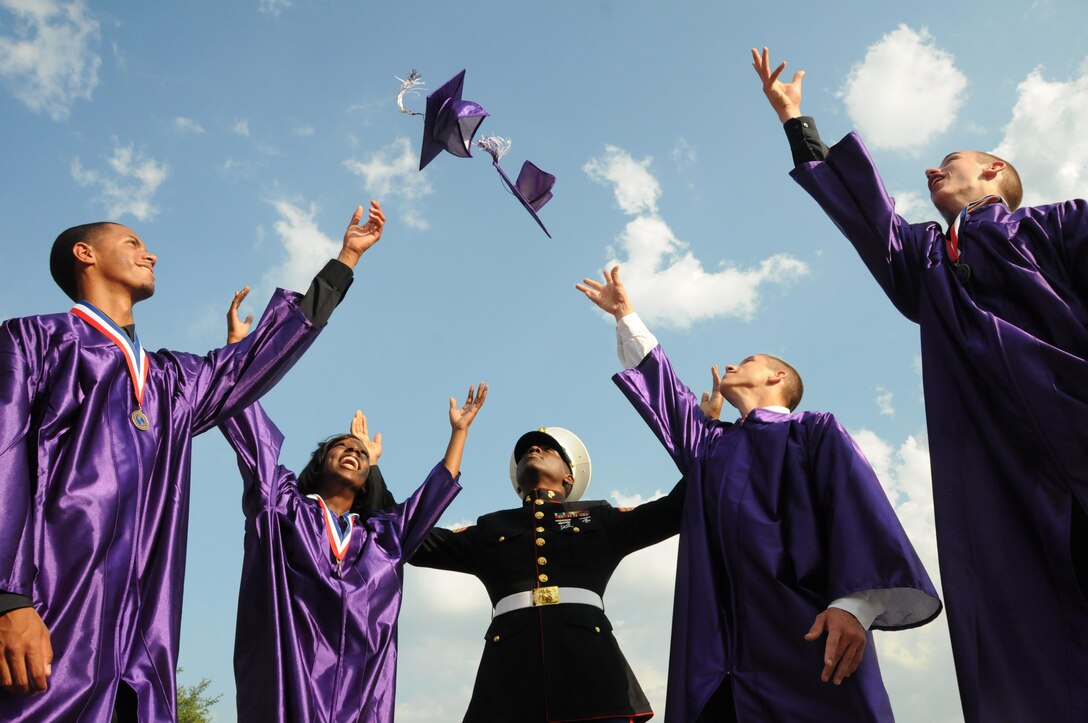 Four students from Fort Worth, Texas-based Crowley High School toss their caps into the sky here. The four joined the Marine Corps through the Delayed Entry Program while they still were in school. Gunnery Sgt. Billy D. Randall, staff noncommissioned officer-in-charge for Recruiting Substation Fort Worth, Recruiting Station Fort Worth is pictured in the center. (Official U.S. Marine Corps photo by Sgt. Ray Lewis)