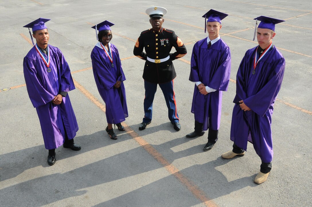 Four students from Fort Worth, Texas-based Crowley High School joined the Marine Corps through the Delayed Entry Program while they still were in school here. Gunnery Sgt. Billy D. Randall, staff noncommissioned officer-in-charge for Recruiting Substation Fort Worth, Recruiting Station Fort Worth is pictured in the center.