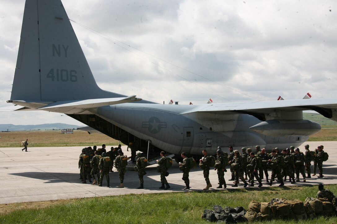 Romanian static-line paratroopers enter a KC-130T Hercules Aircraft from Marine Aerial Refueler Transport Squadron 452, on the flight line of Campia Turzii, Romania, June 3. A pair of KC-130 Hercules aircraft, from VMGR-452, out of Newburgh, N.Y., and VMGR-234, out of Fort Worth, Texas, are currently deplooyed as the air combat element of the Black Sea Rotational Force Security Cooperation Marine Air-Ground Task Force.