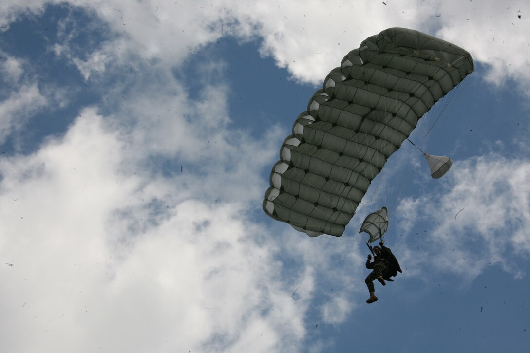 A Romanian paratrooper soars in the skies over Campia Turzii, June 3. Romanian paratroopers conducted static-line and military free fall airborne training with the help of U.S. Marine Corps KC-130 Hercules aircraft, June 2-3. Romanian and U.S. forces are slated to conduct more paratrooper training, June 8-9.