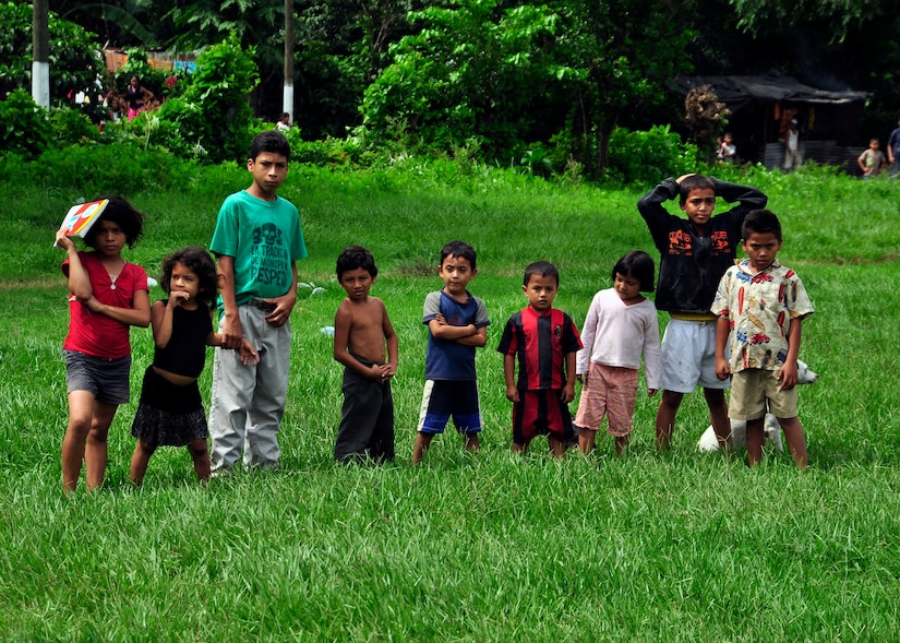 Children of Masagua, Guatemala watch as disaster relief supplies are offloaded from a Joint Task Force-Bravo UH-60 Blackhawk June 3. Joint Task Force-Bravo deployed four helicopters, at the request of the Guatemalan government, to support disaster relief efforts following the Pacaya Volcano eruption and Tropical Storm Agatha. Joint Task Force-Bravo’s helicopters and personnel have helped transport more than 40,000 lbs. of relief supplies to six Guatemalan communities in need. (U.S. Air Force photo by Staff Sgt. Bryan Franks)