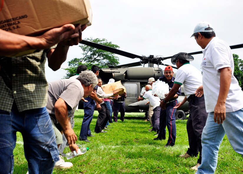 Residents of Masagua, Guatemala offload food and water from a Joint Task Force-Bravo UH-60 Blackhawk June 3. Joint Task Force-Bravo deployed four helicopters, at the request of the Guatemalan government, to support disaster relief efforts following the Pacaya Volcano eruption and Tropical Storm Agatha. Joint Task Force-Bravo’s helicopters and personnel have helped transport more than 40,000 lbs. of relief supplies to six Guatemalan communities in need. (U.S. Air Force photo by Staff Sgt. Bryan Franks)