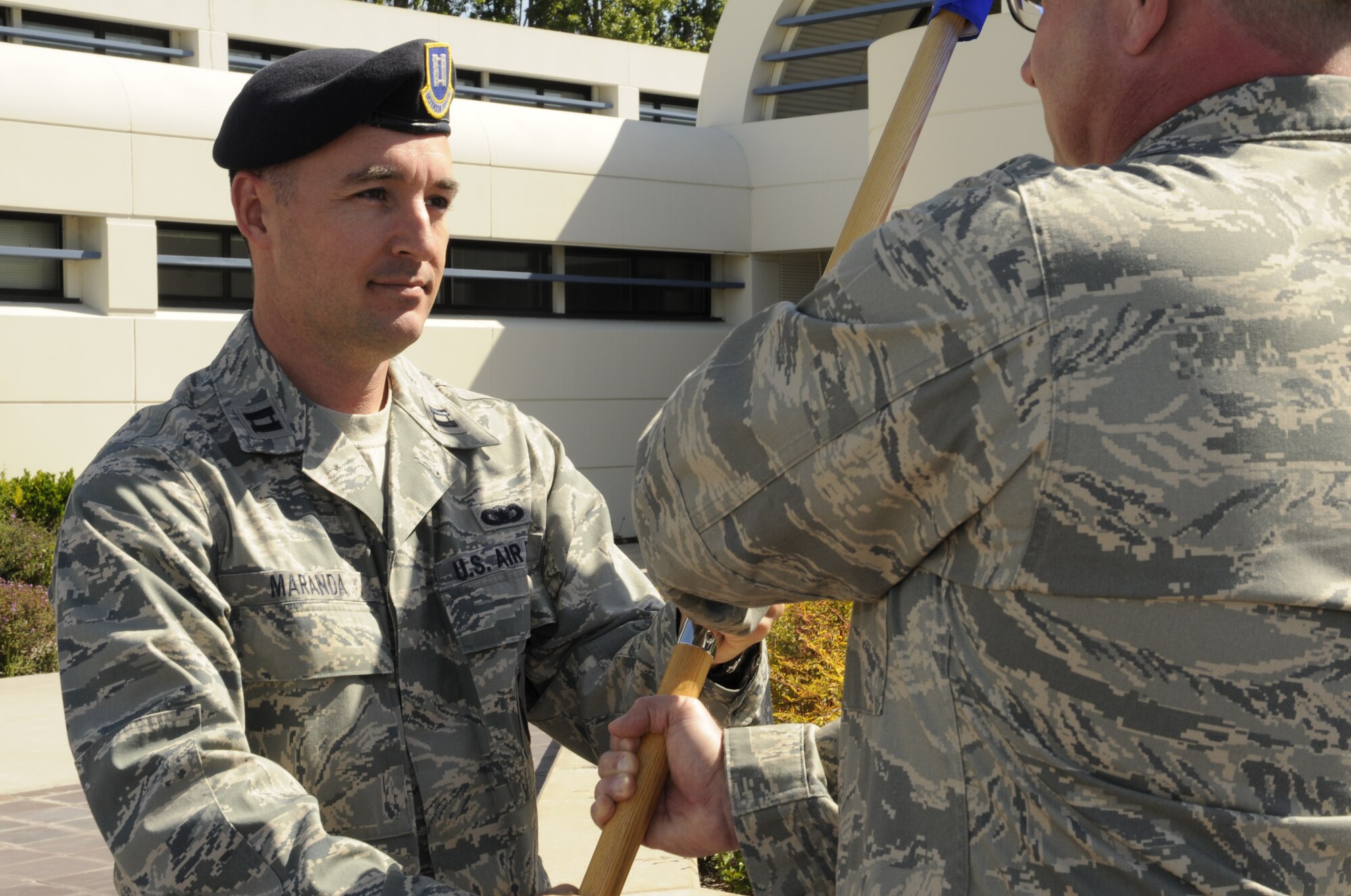 Capt. Thomas Maranda, the former 129th Security Forces Squadron operations officer, accepts the SFS guidon from Col. Charles Ingalls, the 129th Mission Support Group commander at an assumption of command ceremony May 1, 2010 at Moffett Federal Airfield, Calif. Colonel Ingalls temporarily held command of Security Forces while Captain Maranda was at technical training to become the SFS commander. (Air National Guard photo by Staff Sgt. Kim Ramirez)