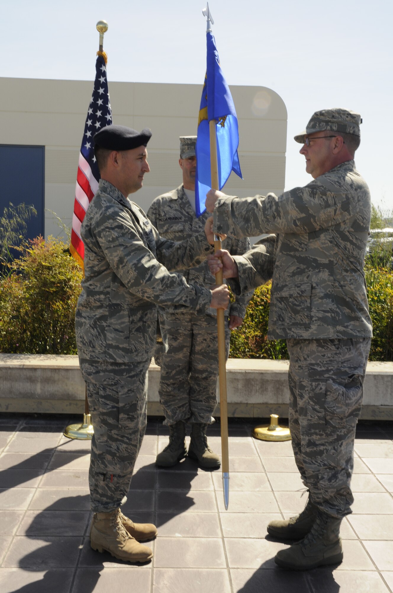 Col. Charles Ingalls, the 129th Mission Support Group commander presents the 129th Security Forces guidon to Capt. Thomas Maranda, the former 129th SFS operations officer in an assumption of command ceremony May 1, 2010 at Moffett Federal Airfield, Calif. Captain Maranda is assuming command of the 129th SFS. Colonel Ingalls temporarily held command of Security Forces while Captain Maranda was at technical training to become the 129th SFS commander. (Air National Guard photo by Staff Sgt. Kim Ramirez)