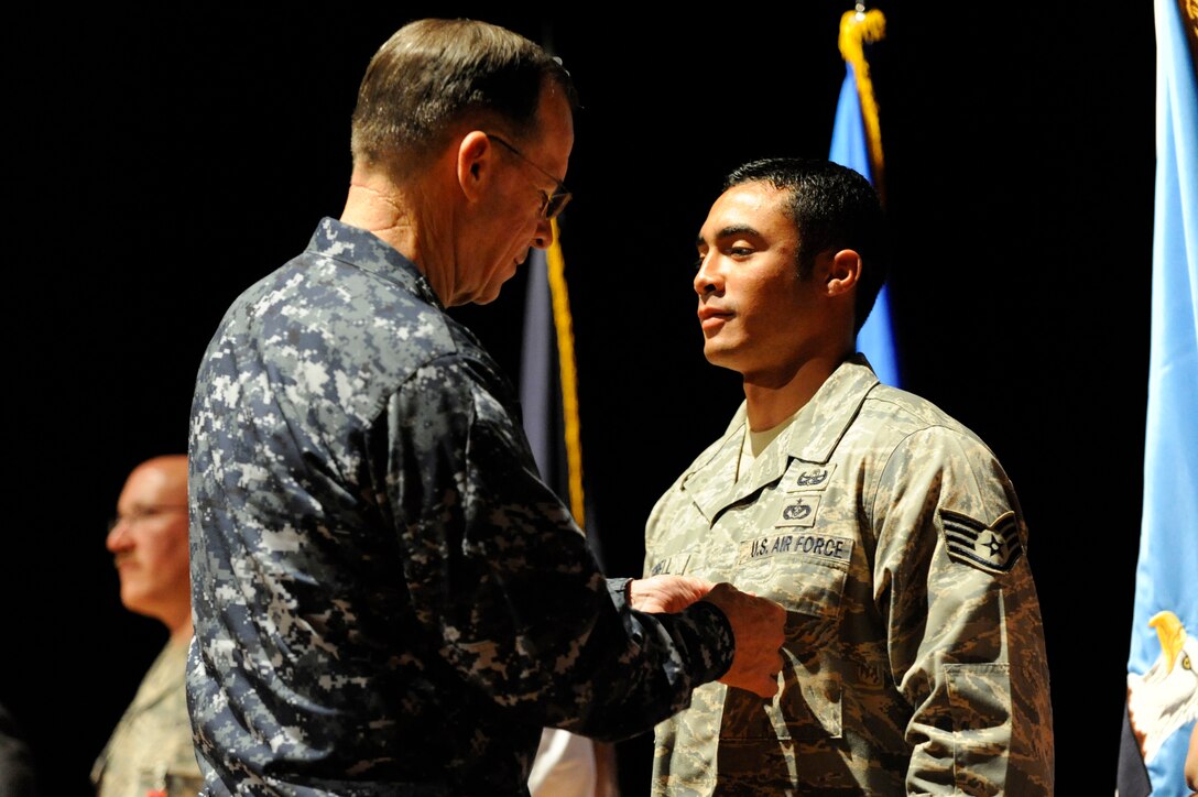 U.S. Navy Adm. Mike Mullen pins a Bronze Star on U.S. Air Force Staff Sgt. Christopher Ferrell at the base theater on Joint Base Charleston, S.C., June 3, 2010. Sergeant Ferrell earned the medal during a recent deployment in support of Operation Enduring Freedom. During his visit, Admiral Mullen fielded questions from Airmen and addressed Department of Defense policy changes and expectations during an all hands call. Admiral Mullen is the Chairman of the Joint Chiefs of Staff, and Sergeant Ferrell is a noncommissioned officer in charge of training with the 628th Civil Engineer Squadron. (U.S. Air Force Photo/James M. Bowman)
