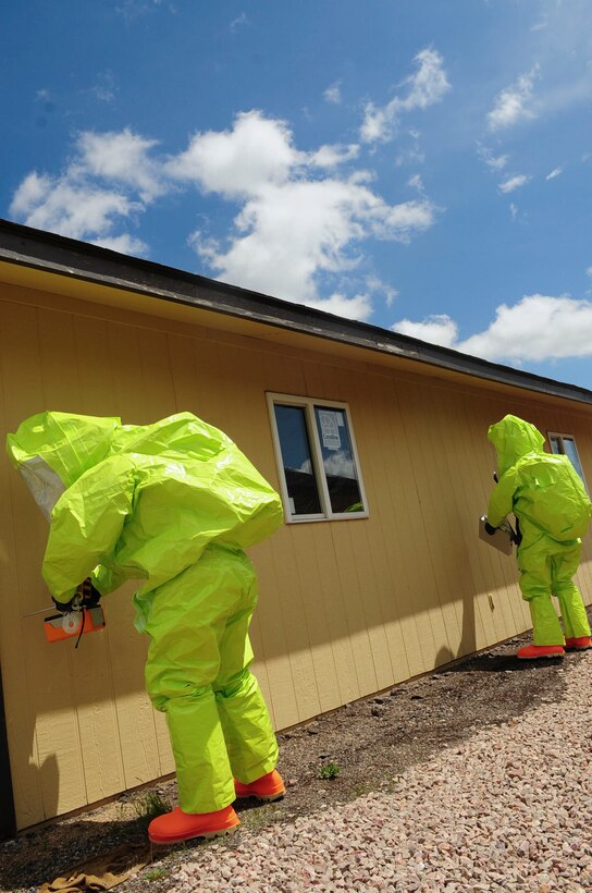 ELLSWORTH AIR FORCE BASE S.D. - (Right) Airmen 1st Class David Jack and Matthew Hung, 28th Civil Engineer Squadron emergency management journeymen, participate in an emergency management exercise, June 3.  The exercise is performed to maintain skills needed in chemical, biological, radiological and nuclear detection and decontamination operations as well as emergency management command and control for real world incidents. (U.S. Air Force photo/Airman 1st Class Corey Hook)
