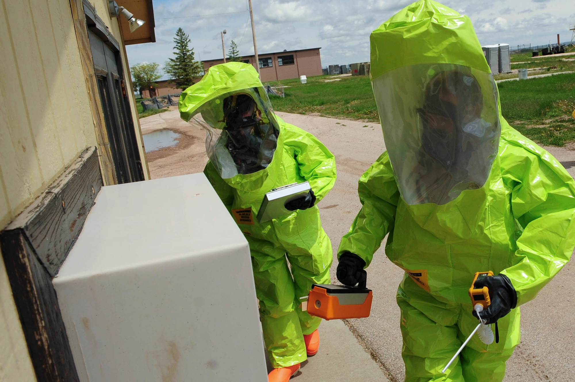 ELLSWORTH AIR FORCE BASE S.D. - (Right) Airmen 1st Class David Jack and Matthew Hung, 28th Civil Engineer Squadron emergency management journeymen, participate in an emergency management exercise, June 3.  Both Airmen perform chemical, biological, radiological and nuclear detection and decontamination operations as well as emergency management command and control.  (U.S. Air Force photo/Airman 1st Class Corey Hook)