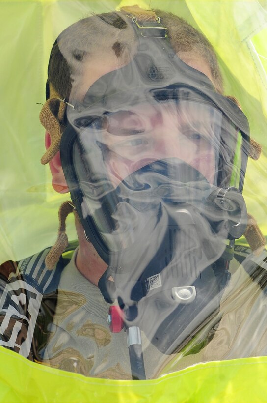 ELLSWORTH AIR FORCE BASE S.D. - Airman 1st Class David Jack, 28th Civil Engineer Squadron emergency management journeyman, is fitted in a level A suit before participating in an emergency management exercise, June 3.  In real world incidents, level A suits are donned when emergency responders deal with an unknown variable in a chemical, biological, radiological and nuclear environment. (U.S. Air Force photo/Airman 1st Class Corey Hook)