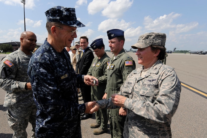 U.S. Navy Adm. Mike Mullen coins U.S. Air Force coins Col. Martha Meeker on Joint Base Charleston, S.C., June 3, 2010. During his visit, Admiral Mullen fielded questions from officers and enlisted Airmen and addressed Department of Defense policy changes and expectations during an all hands call. Admiral Mullen is the Chairman of the Joint Chiefs of Staff, and Colonel Meeker is the commander for the 628th Air Base Wing.  (U.S. Air Force Photo/James M. Bowman)