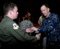 U.S. Navy Adm. Mike Mullen coins an Airman after an all-hands call at the base theater on Joint Base Charleston, S.C., June 3, 2010. During his visit, Admiral Mullen fielded questions from officers and enlisted Airmen and addressed Department of Defense policy changes and expectations. Questions asked ranged from concerns with manning to the removal of fast food in deployed locations. Admiral Mullen is the Chairman of the Joint Chiefs of Staff. (U.S. Air Force Photo/Airman 1st Class Lauren Main)