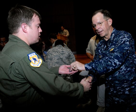U.S. Navy Adm. Mike Mullen coins an Airman after an all-hands call at the base theater on Joint Base Charleston, S.C., June 3, 2010. During his visit, Admiral Mullen fielded questions from officers and enlisted Airmen and addressed Department of Defense policy changes and expectations. Questions asked ranged from concerns with manning to the removal of fast food in deployed locations. Admiral Mullen is the Chairman of the Joint Chiefs of Staff. (U.S. Air Force Photo/Airman 1st Class Lauren Main)
