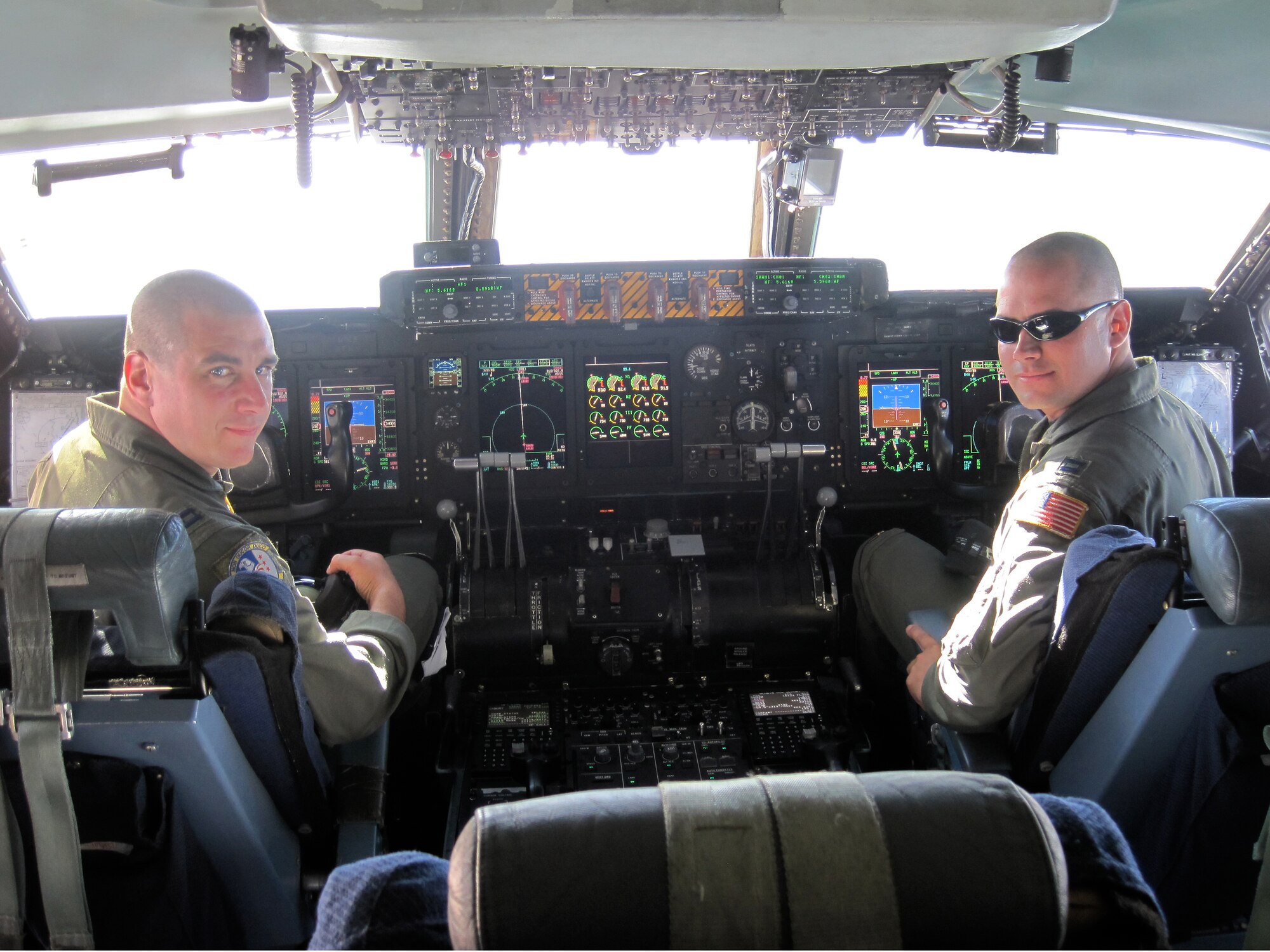 Major Scott Kuhrt (right, pictured as captain) and Captain Jonathan Beale pose with freshly shaved heads aboard a Westover C-5.  In observance of tradition, the missions air crew shaved their heads because it was the first time several members of the crew flew on a point-to-point, around the world trip.  Major Kuhrt also learned of his selection to the rank of major during the mission. 