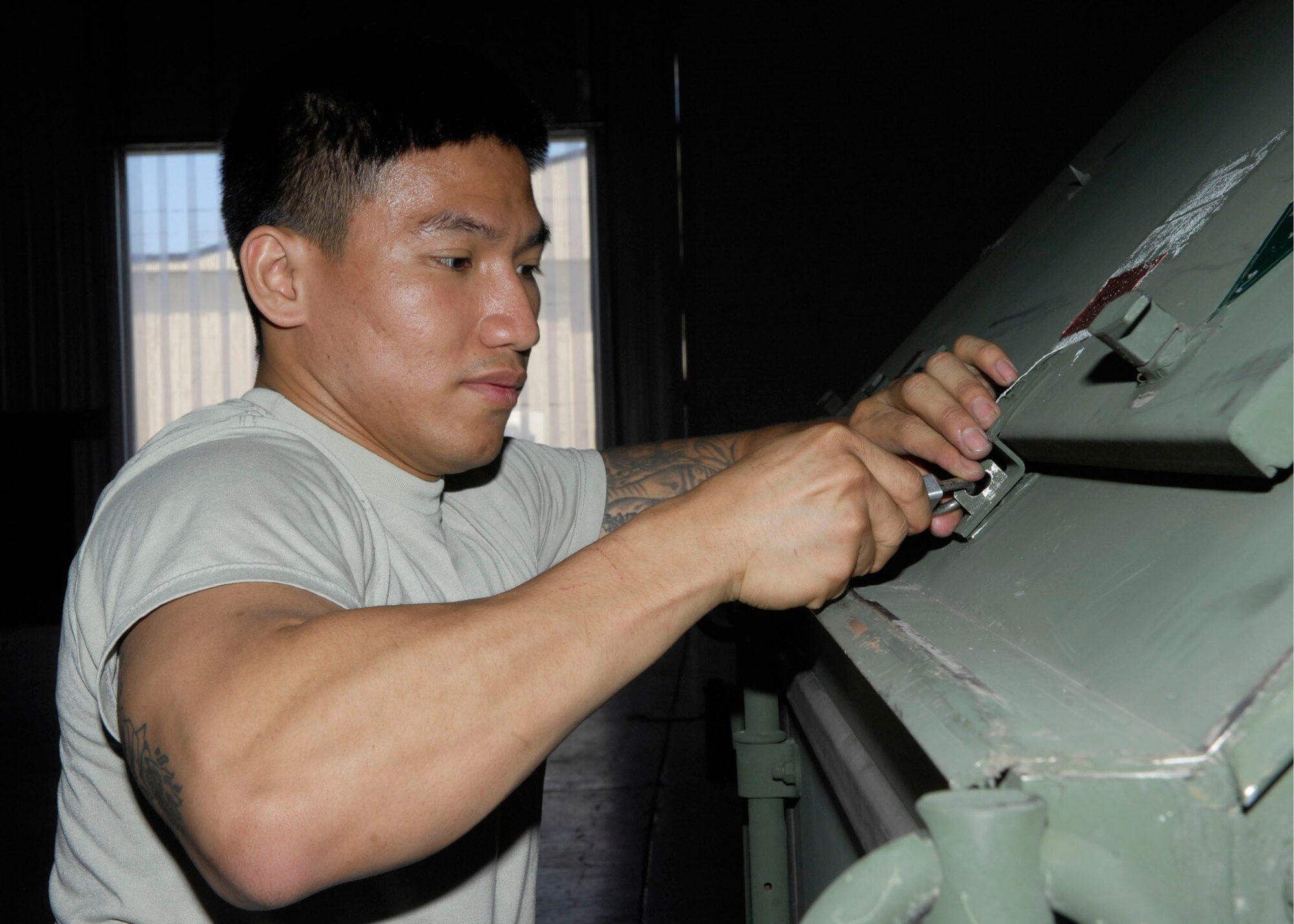 Senior Airman Mark Galvan ensures that supplies are securely locked May 26, 2010, at Minot Air Force Base, N.D. The containers are filled with supplies and equipment 5th Bomb Wing deployers will need to support the U.S. Pacific Command's mission at Andersen Air Force Base, Guam. Airman Galvan is a 5th Operations Support Squadron aircrew flight equipment technician. (U.S. Air Force photo/Senior Airman Ashley N. Avecilla)