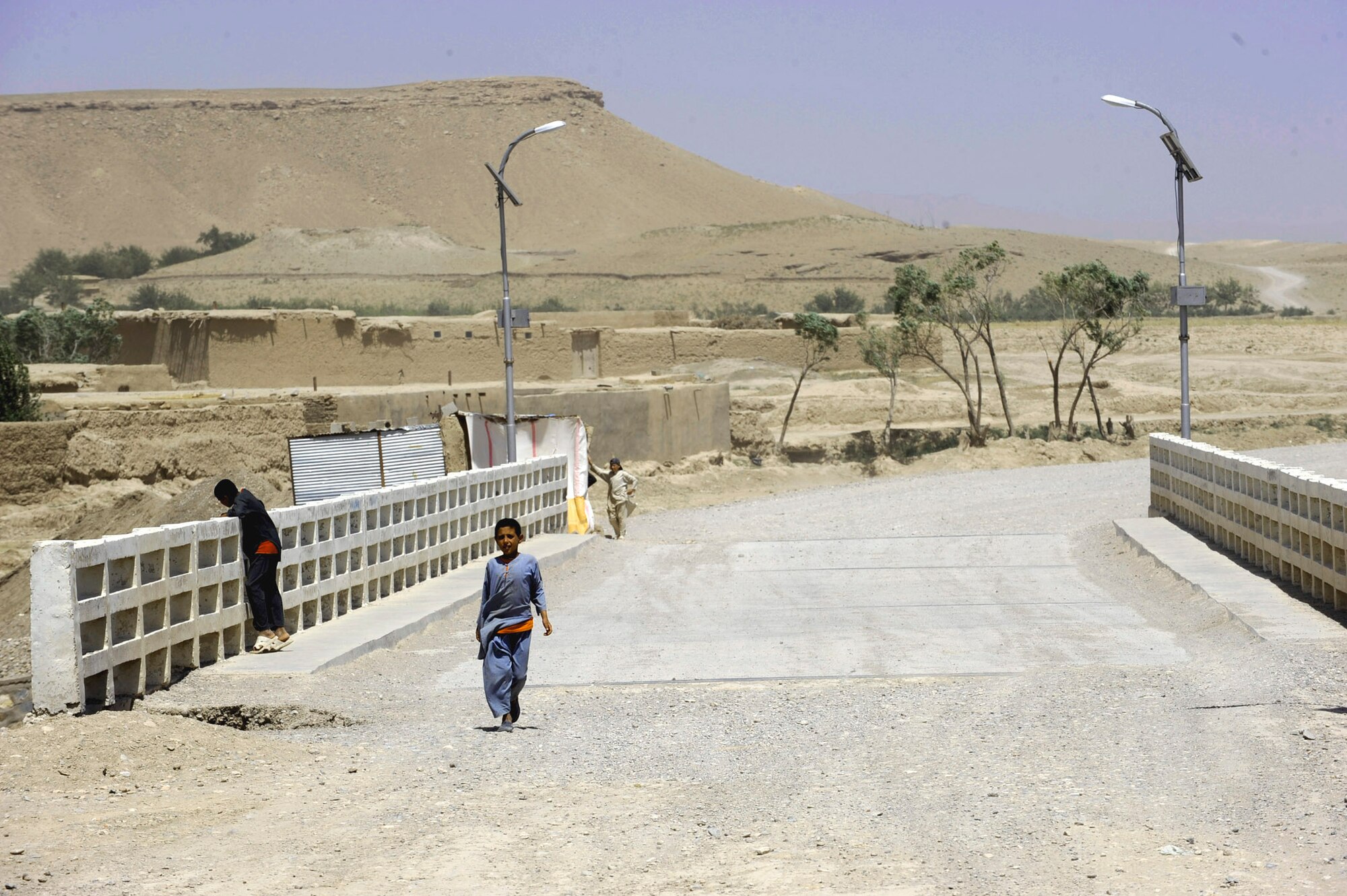 Afghan children cross the Tarnak Bridge, which is being repaired by Provincial Reconstruction Team Zabul and Zabul Province government officials May 27, 2010, in Qalat City, Afghanistan. (U.S. Air Force photo/Staff Sgt. Manuel J. Martinez)