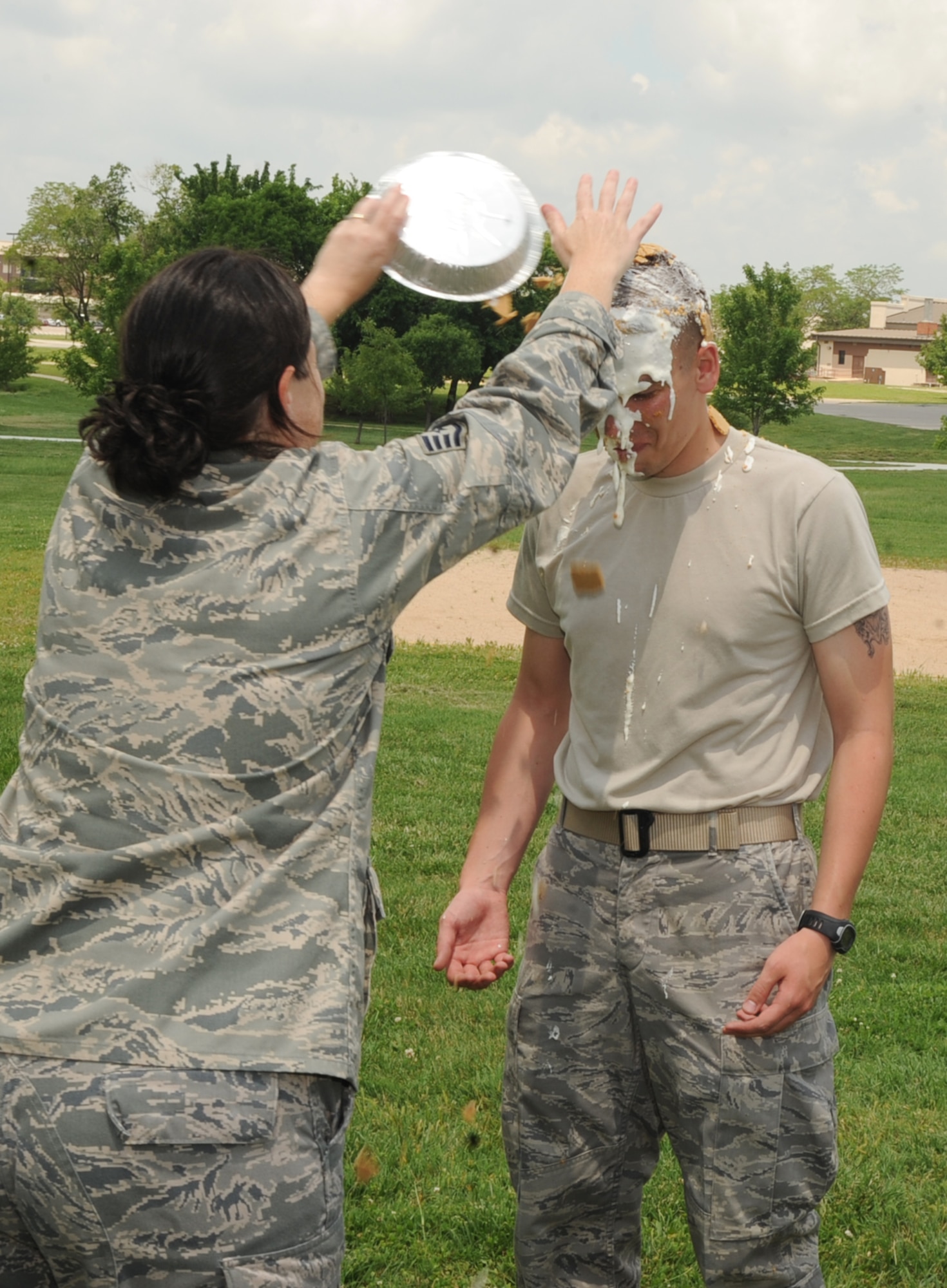 Staff Sgt. Stacey Clouse, 22nd Medical Support Squadron NCOIC of customer service, throws a pie on the face of Airman 1st Class Patrick Demoe, 22nd Medical Support Squadron medical logistics journeyman, during a contest at the Airman’s Council burger burn May 28, 2010, McConnell Air Force Base, Kan. Team McConnell Airmen made donations for a chance to throw a pie in someone’s face and help raise approximately $500 in funds for the Airman’s Council. The burger burn is a wing event and assists in building Team McConnell Airmen’s morale by offering an opportunity to unwind with food and games. (U.S. Air Force photo/Senior Airman Maria Ruiz)